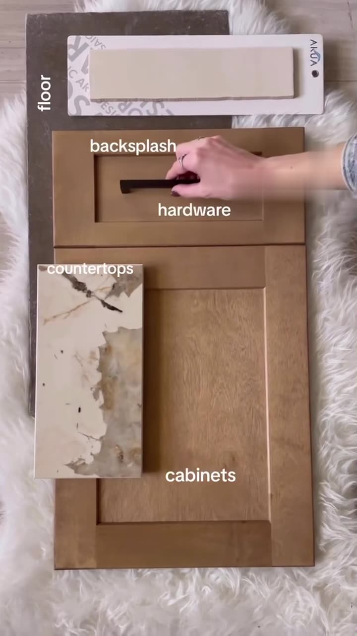Cabinet door, countertop and hardware samples laid out side by side at the Cabinet Bazaar showroom
