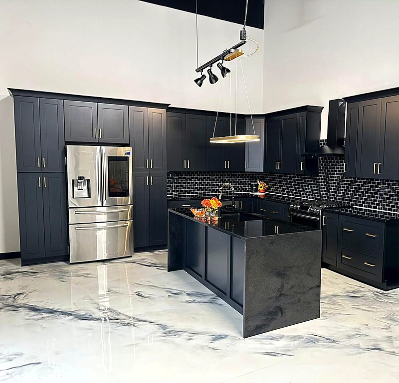 Black shaker kitchen with a quartz waterfall island and marble floor