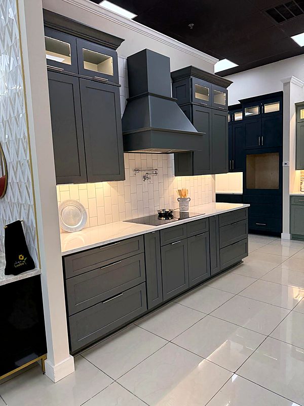 Gray Shaker kitchen with range hood — trade project by Cabinet Bazaar