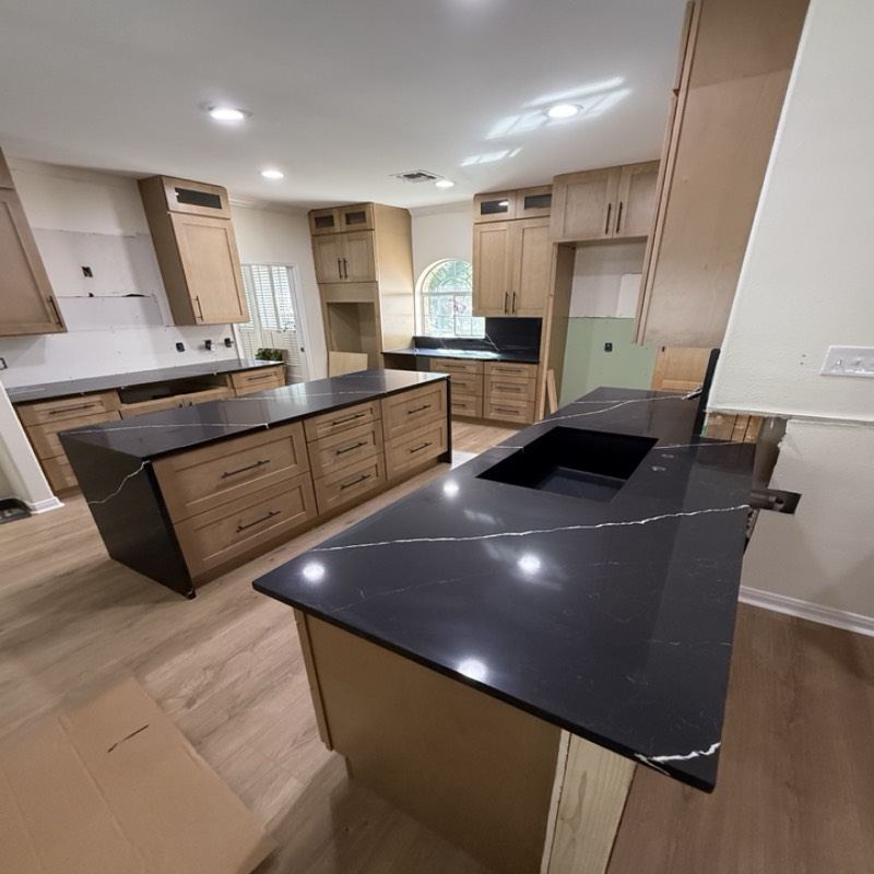 Natural maple shaker kitchen with a black quartz waterfall island