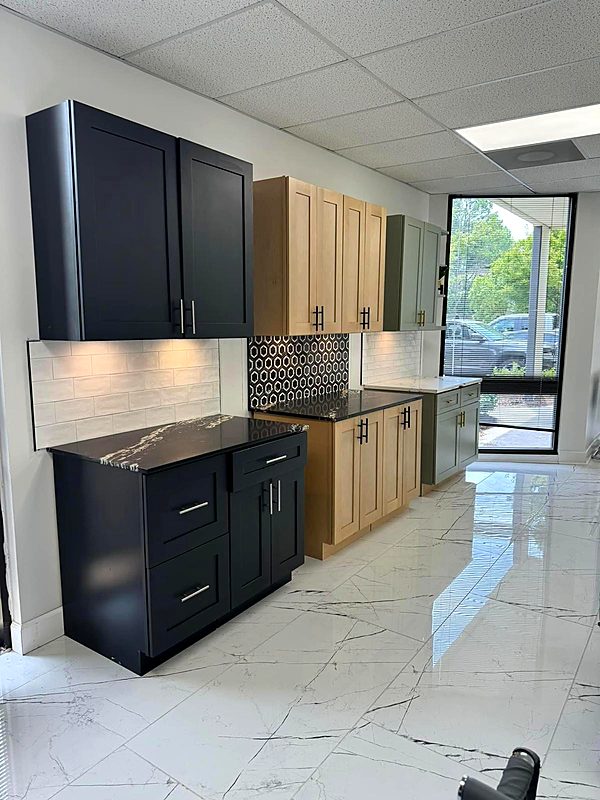 Navy blue kitchen cabinets with a mosaic tile backsplash and marble floor