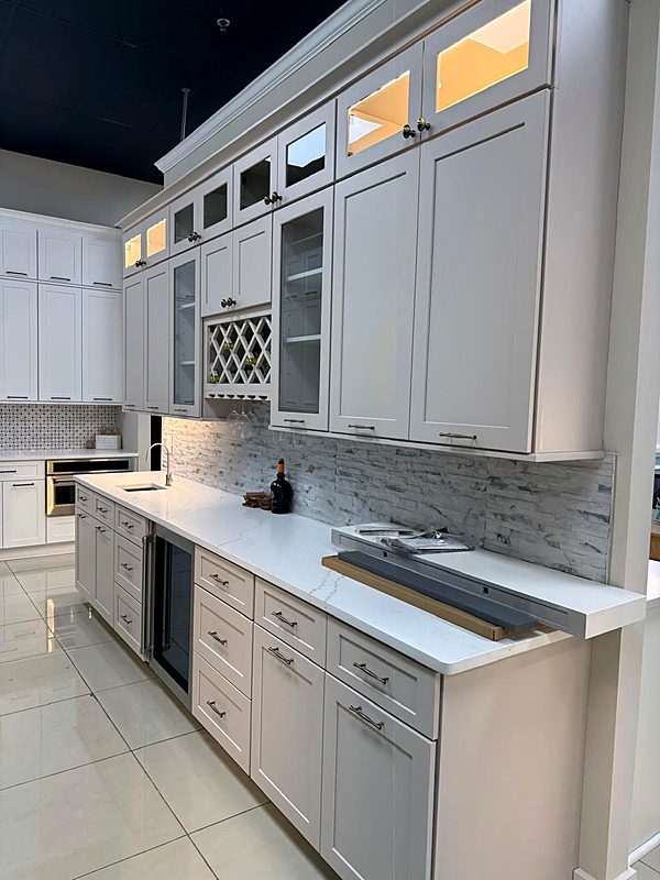 White kitchen with glass upper cabinets and a built-in wine rack
